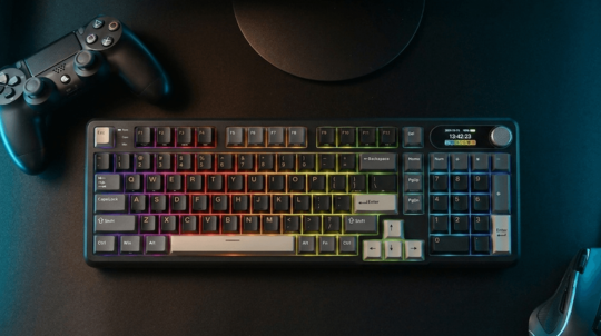 Gaming keyboard with RGB lighting on a dark surface next to a gaming controller.